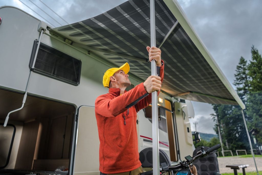 Man opens awning on an RV